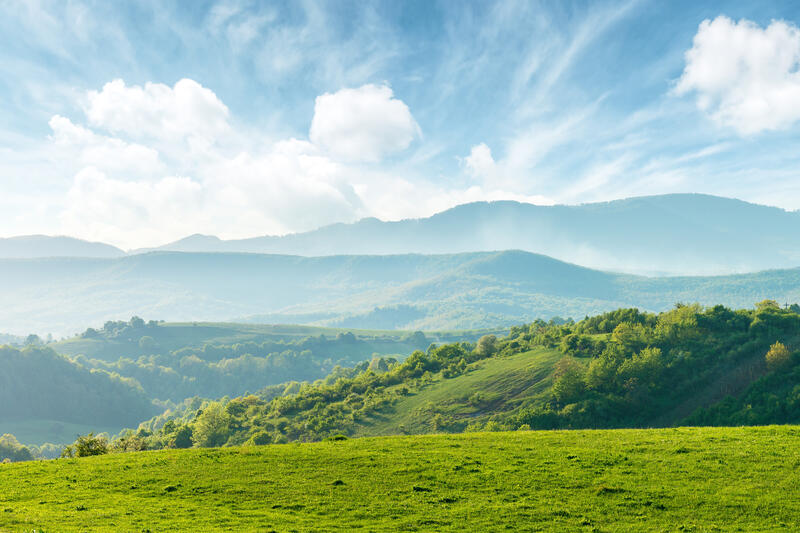 An outdoor scene with rolling green hills